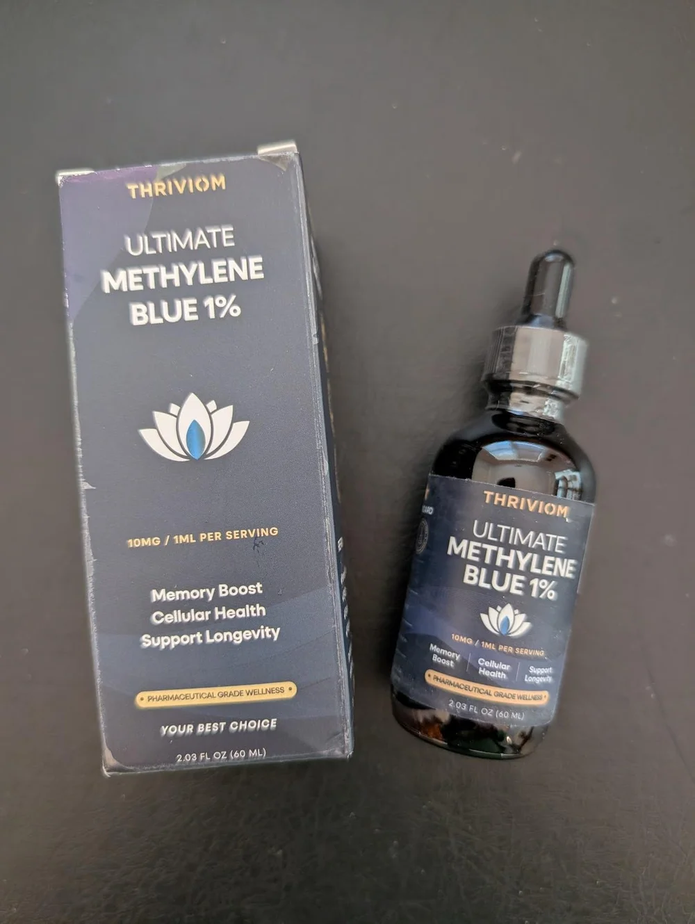 Thriviom Ultimate Methylene Blue 1% box and bottle side by side on a dark countertop
