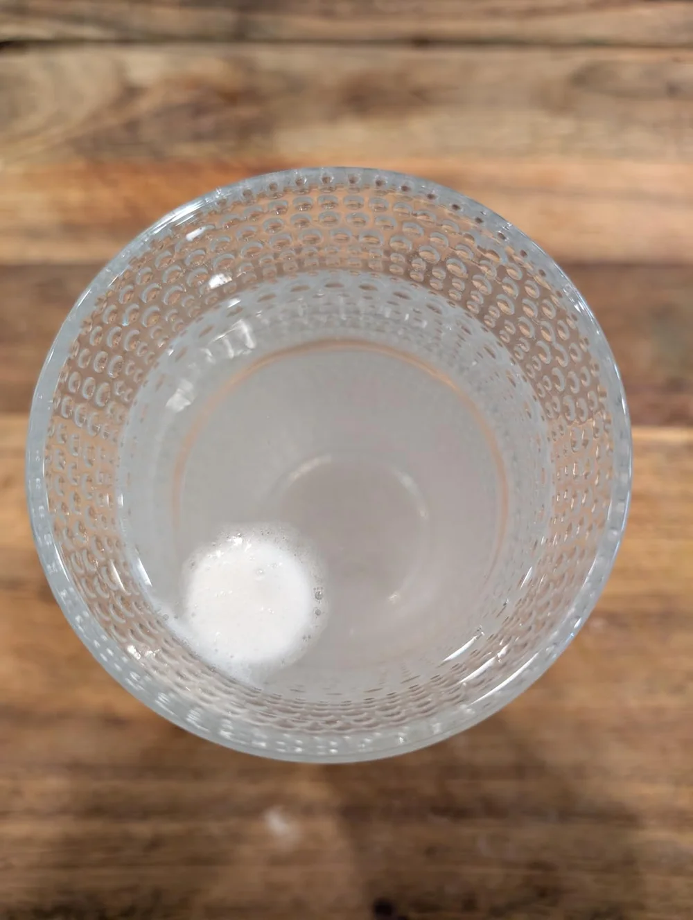 Tablet dissolving in a glass of water, early stage