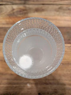 Tablet dissolving in a glass of water, early stage