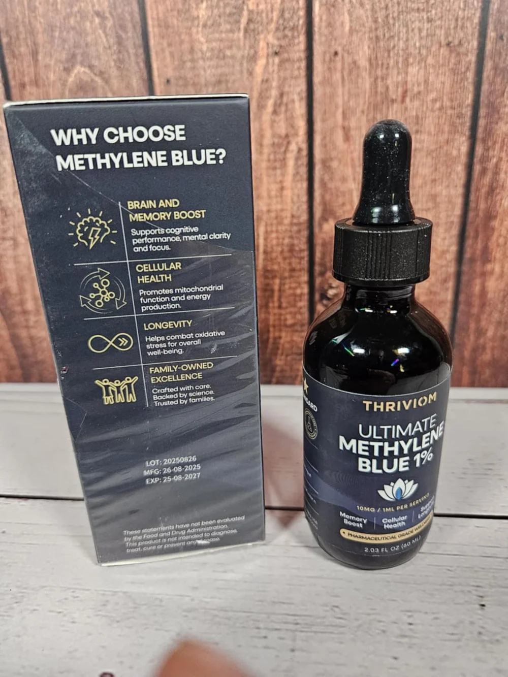 Thriviom Ultimate Methylene Blue 1% box and bottle on a rustic wooden surface