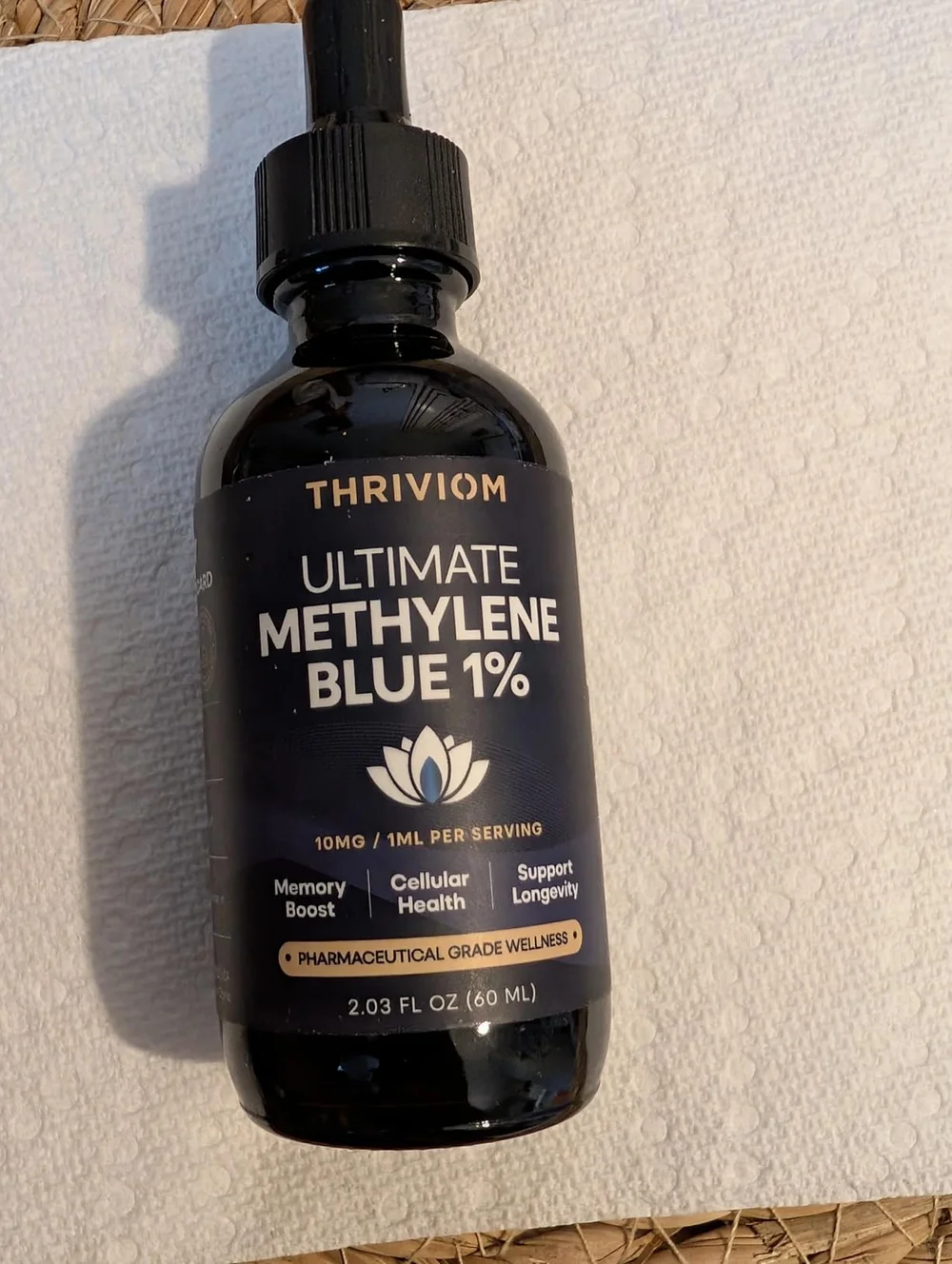 Thriviom Ultimate Methylene Blue 1% bottle standing on a folded white towel